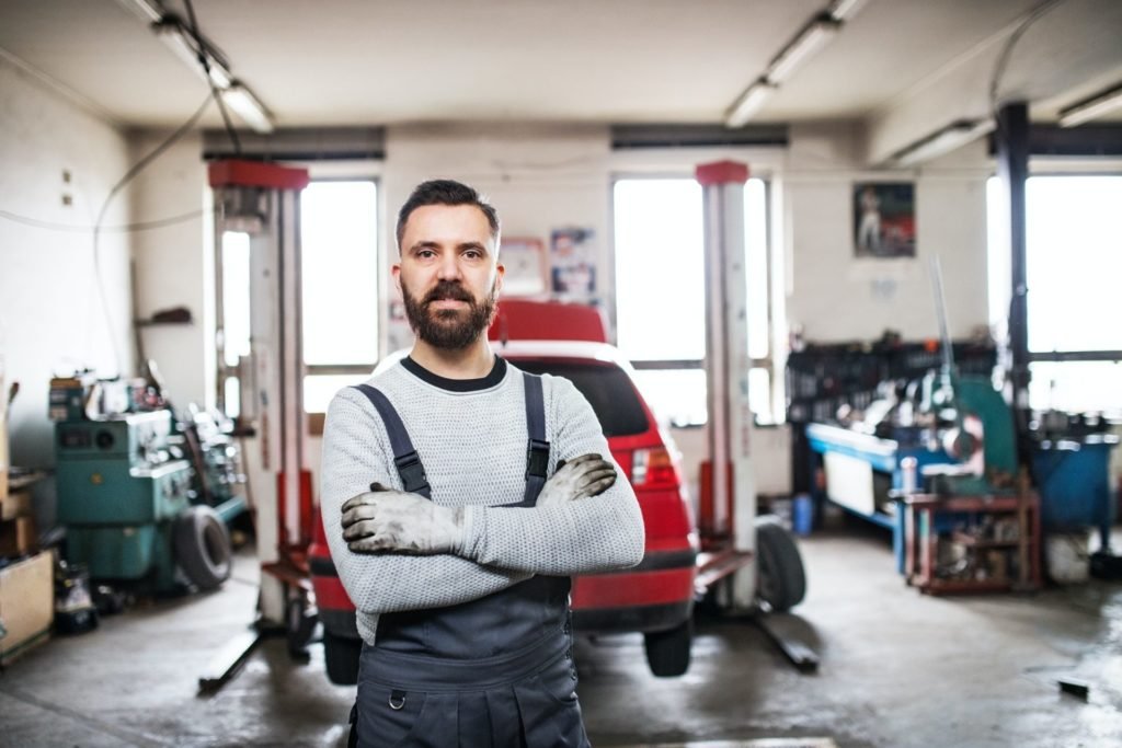 Portrait of a man mechanic in a garage.